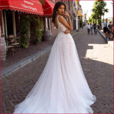 Long white v-neck wedding dress with open back design for bohemian brides