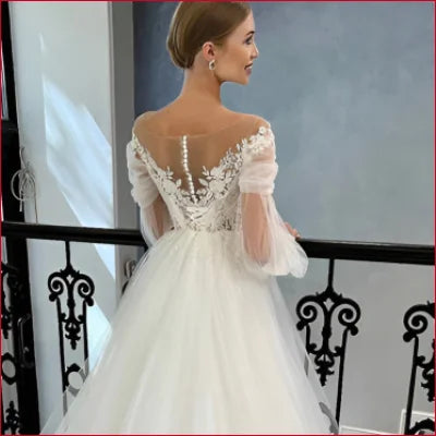 Elegant long sleeves bridal gown featuring lace details and sheer long sleeves