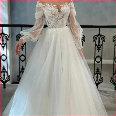 Elegant long sleeves bridal gown in white with lace bodice and sheer sleeves