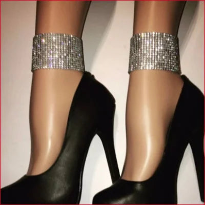 Black high heels featuring sparkling silver ankle straps for stylish women’s jewelry