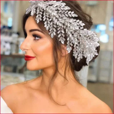 Ornate silver leaf hair accessory in updo for a striking bridal wedding look