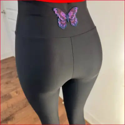 Black butterfly leggings yoga pants featuring a purple butterfly design on the back