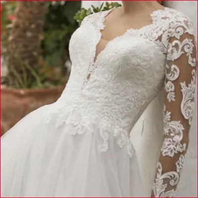 Elegant long sleeves bridal gown in white with lace detailing and long sleeves