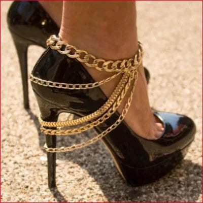 Black patent leather high heel shoe with gold chain, ideal for styling with ankle chain bracelet