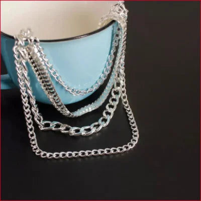 Multi-strand silver chain bracelet with varying link styles for stylish ankle chains