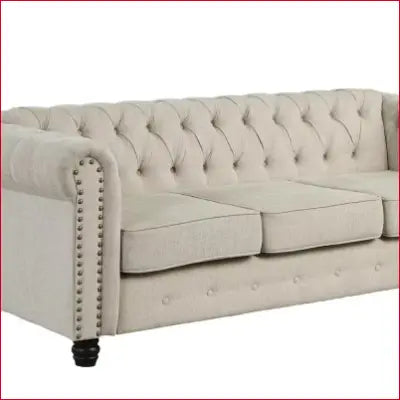 Tufted beige Chesterfield sofa with button-tufted accenting and scrolled arms for living room