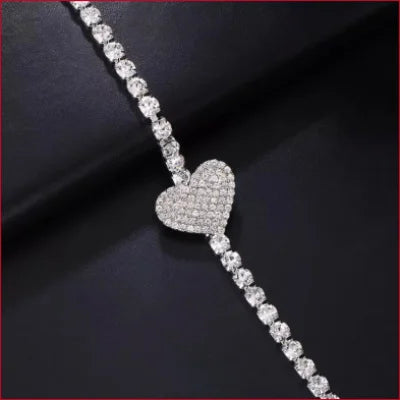 Diamond-encrusted heart pendant on a sparkling tennis bracelet for heart cleavage chest