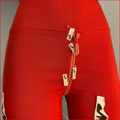 Crotch zipper red leggings with decorative zipper and musical note appliqués