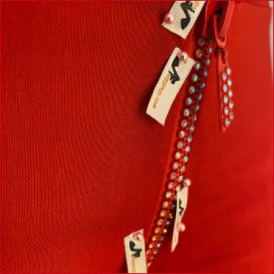 Strand of blue beads on red background with Crotch Zipper Red Leggings tags displayed