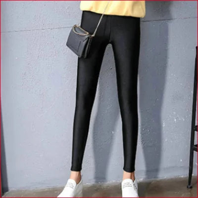 Sparkly Shiny Black Spandex Disco Leggings styled with white sneakers and a handbag