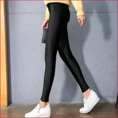 Sparkly Shiny Black Spandex Disco Leggings paired with white sneakers for a stylish look