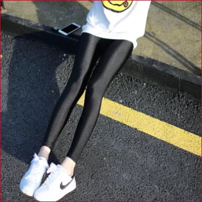 Black spandex disco leggings paired with white Nike sneakers for a stylish look