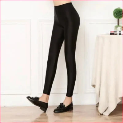 Black high-waisted shiny black spandex disco leggings paired with flat loafers