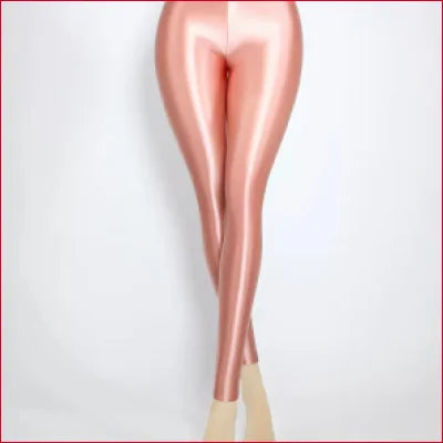 Pair of disco quality shiny glossy leggings displayed on crossed legs in pink