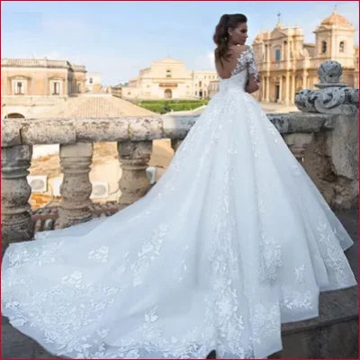 Ornate ivory wedding gown featuring a voluminous skirt and intricate lace detailing