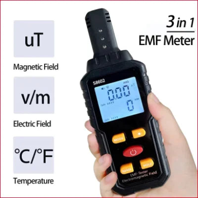 Handheld EMF detector tester showing magnetic field, electric field, and temperature readings