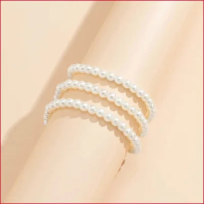 Size adjustable faux pearls bracelet elegantly wrapped around a wrist for a chic look