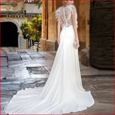 Elegant Feathers Wedding Dress in White with lace back and flowing train detail