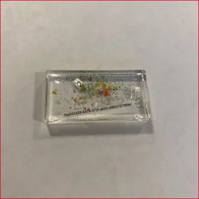 Clear rectangular block with colorful particles in unique NFT jewelry from Nov 21st