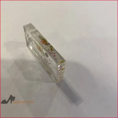 Clear resin block with colorful flakes in Unique NFT Jewelry Nov 21st display