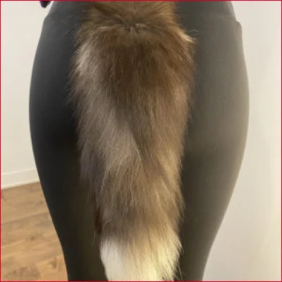 Fluffy light brown foxtail on dark surface of Foxtail Black Spandex Leggings NFT