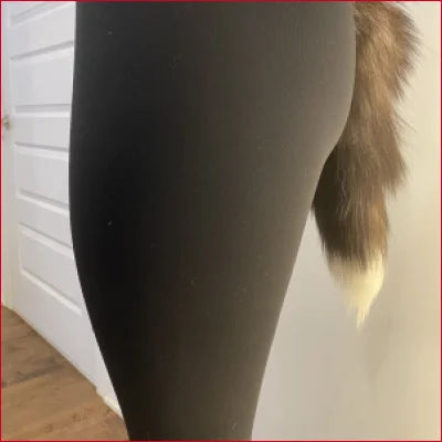 Furry foxtail attached to person in Foxtail Black Spandex Leggings NFT показать