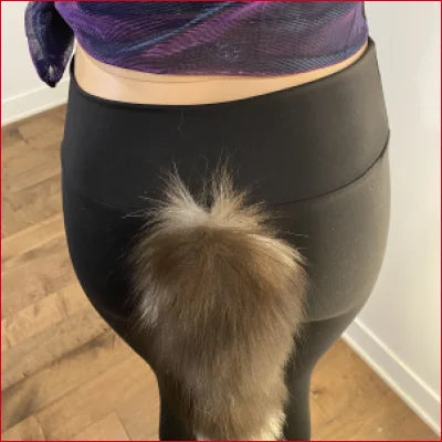 Fluffy dog tail peeking from Foxtail Black Spandex Leggings NFT on DeviantArt