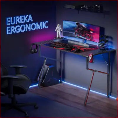 Gaming desk showcasing accessories in a K shaped home office design with carbon fiber finish