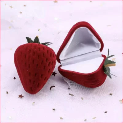 Strawberry-shaped ring box with white interior displaying Sterling Silver Green Leaf Stud Earrings