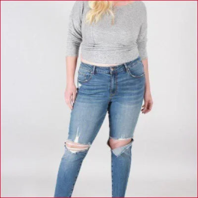 Distressed blue Super Stretchy Skinny Jeans with rips at the knees for a stylish look