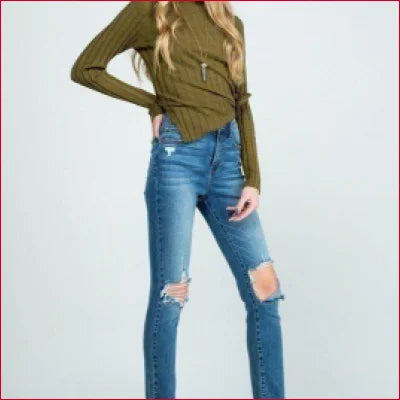 Destroyed skinny denim jeans with clean hem, worn with an olive green top