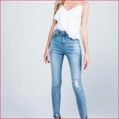 Distressed light blue skinny jeans with rips and medium-light wash design