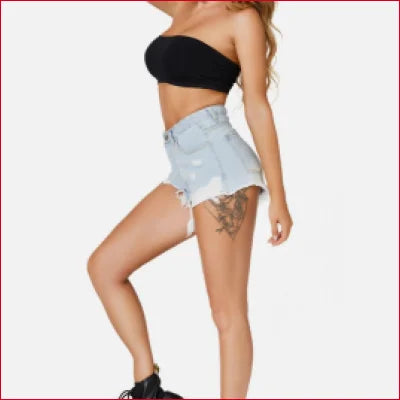 Woman in a black tube top and light denim showing Super Soft Distressed Cut Off Shorts