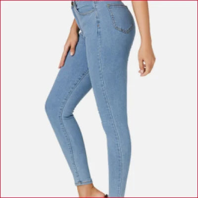 Light blue high rise slim fit jeans worn on a person’s lower body