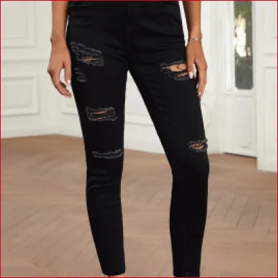 Distressed black high waist ripped skinny jeans showcasing trendy street style