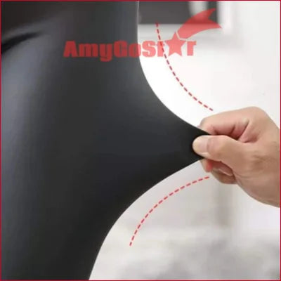 Finger tracing red dotted lines on a curved white surface of Black Matt Faux Leather Leggings