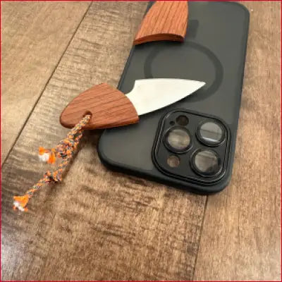 Miniature knife with wooden handle and braided lanyard as a box letter opener for iPhone 14 Plus black case