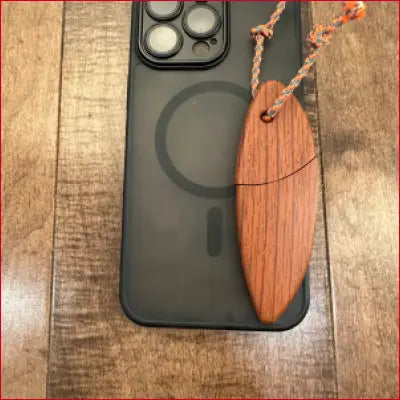 Black phone with wooden surfboard-shaped USB drive in iPhone 14 Plus Black Case Box Letter Opener