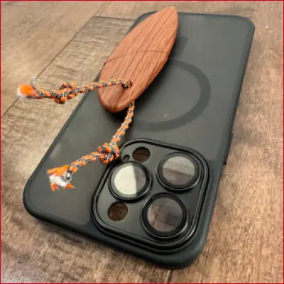 Black iPhone 14 Plus case with wooden surfboard charm and box letter opener