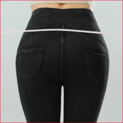 Pair of tight-fitting black jeggings jean leggings showcased from the back