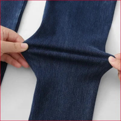 Hands folding dark blue jeggings jean leggings for a stylish look