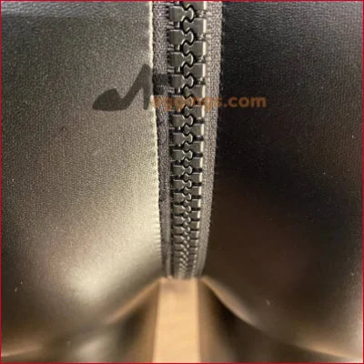 Close-up of a stylish black vegan leather crotch zipper on leggings