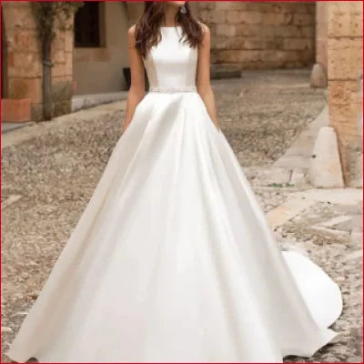 Elegant white wedding dress featuring a sleeveless bodice and lace back A-Line skirt