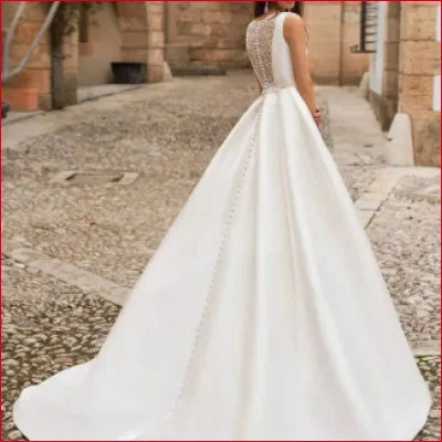 Elegant Lace Back A-Line Wedding Dress in White or Ivory featuring a full skirt and train