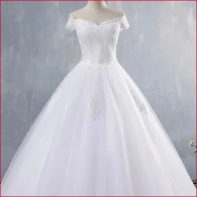 White off-the-shoulder wedding dress princess style with a full skirt for brides