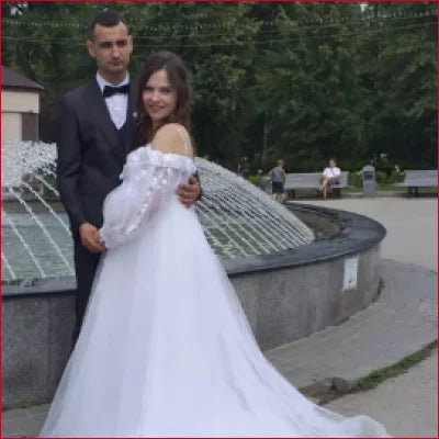 Bride and groom by fountain in Gorgeous Lace Off Shoulder Bridal Gown with crotch zipper