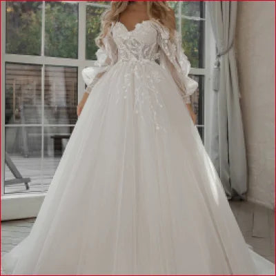 Elegant white bridal gown with gorgeous lace sleeves and tulle skirt, featuring a crotch zipper