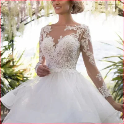 Elegant white wedding dress with tulle lace sleeves and a backless design