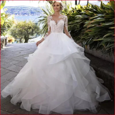 Ornate White and Ivory Wedding Dress with Tulle Lace Sleeves and Voluminous Skirt