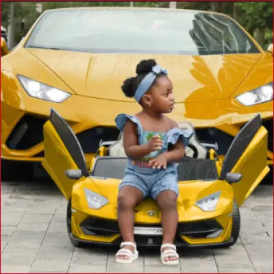 Yellow Lamborghini Aventador alongside child’s toy car, featuring swappable battery 24V and leather seat